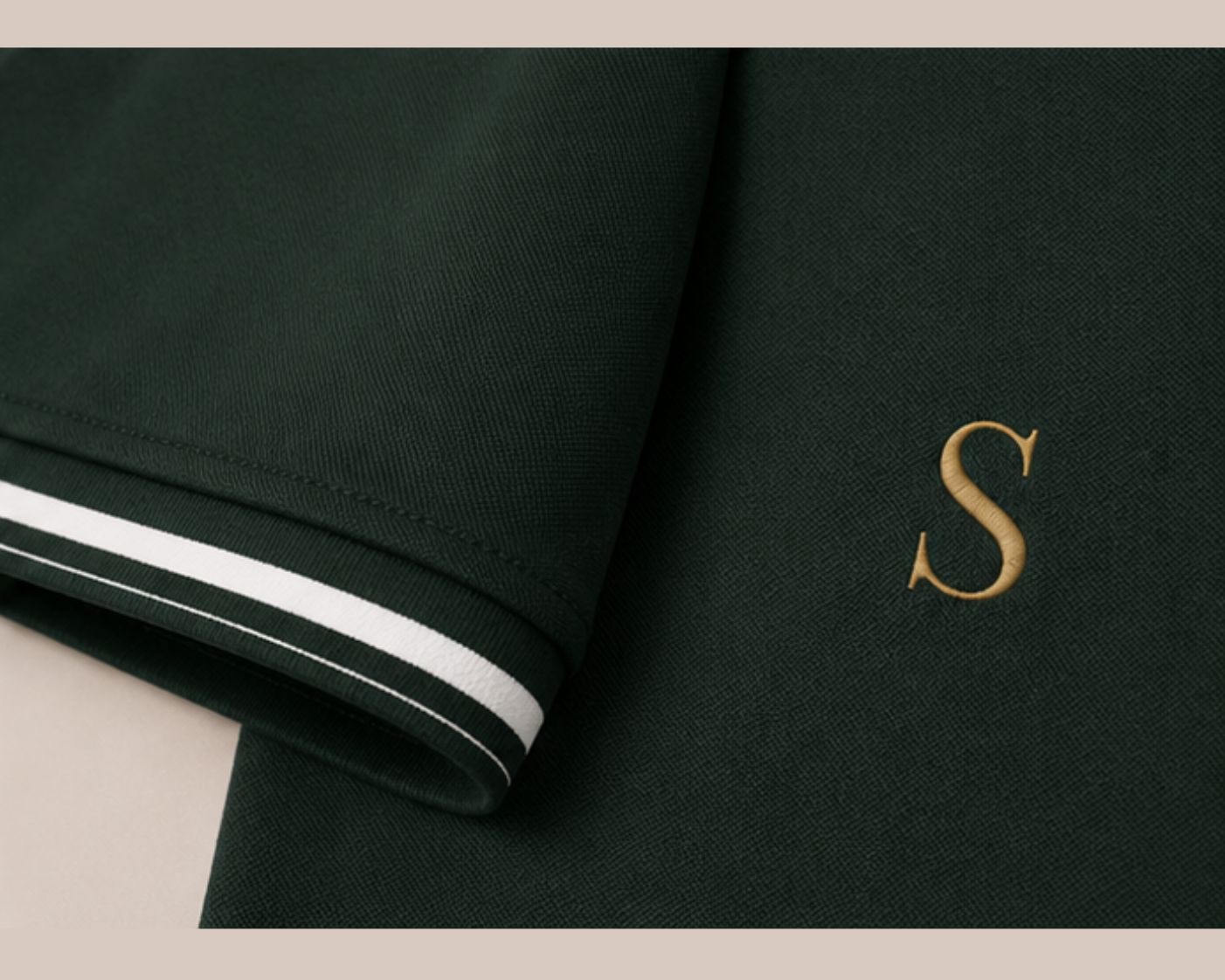 Polo detail — sleeve stripe and monogram